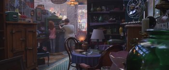 Movie still from “Toy Story 4” (2019), directed by Josh Cooley – A man and a woman are sitting at a table in front of a counter; Wide shot, Over the shoulder angle
