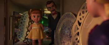 Movie still from “Toy Story 4” (2019), directed by Josh Cooley – A girl and a doll next to a plate on the floor; Medium shot, High angle
