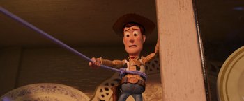 Movie still from “Toy Story 4” (2019), directed by Josh Cooley – A toy story character holding a rope; Medium shot, Low angle