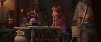 Movie still from “Toy Story 4” (2019), directed by Josh Cooley – A little girl sitting at a table with a book in front of her face; Medium shot, Over the shoulder angle