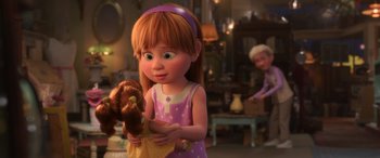 Movie still from “Toy Story 4” (2019), directed by Josh Cooley – A little girl holding a teddy bear in a living room; Medium shot, Over the shoulder angle