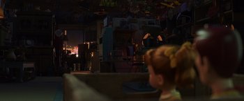Movie still from “Toy Story 4” (2019), directed by Josh Cooley – A person sitting in a chair in a living room; Wide shot, Over the shoulder angle