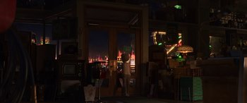 Movie still from “Toy Story 4” (2019), directed by Josh Cooley – A woman standing in front of a store window at night; Wide shot, Over the shoulder angle