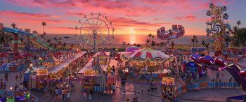 Movie still from “Toy Story 4” (2019), directed by Josh Cooley – An amusement park at sunset with the ocean in the background; Extreme Wide shot, High angle