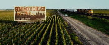 Movie still from “Transformers: Age of Extinction” (2014), directed by Michael Bay – A truck driving down a road next to a field of corn; Extreme Wide shot, High angle