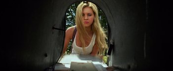 Movie still from “Transformers: Age of Extinction” (2014), directed by Michael Bay – A beautiful young blond haired woman looking into an open mailbox; Medium shot, Low angle