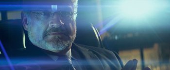 Movie still from “Transformers: Age of Extinction” (2014), directed by Michael Bay – A person wearing a suit and tie; Close Up shot, Low angle