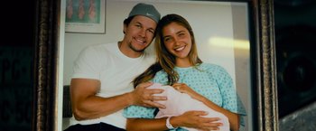 Movie still from “Transformers: Age of Extinction” (2014), directed by Michael Bay – A man and a woman are holding a baby; Close Up shot, Overhead angle