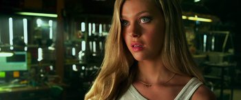 Movie still from “Transformers: Age of Extinction” (2014), directed by Michael Bay – A woman with long blonde hair and green eyes looking at the camera; Close Up shot, Low angle