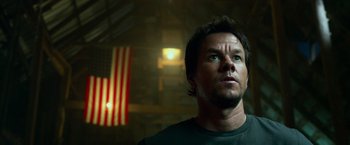 Movie still from “Transformers: Age of Extinction” (2014), directed by Michael Bay – A person with a flag in the background; Close Up shot, Low angle