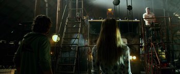 Movie still from “Transformers: Age of Extinction” (2014), directed by Michael Bay – A woman standing in front of a ladder in a room; Wide shot, Low angle