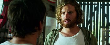 Movie still from “Transformers: Age of Extinction” (2014), directed by Michael Bay – A man with long hair and a beard talking to another man; Close Up shot, Over the shoulder angle