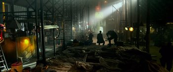 Movie still from “Transformers: Age of Extinction” (2014), directed by Michael Bay – Two men working in an industrial setting in the dark; Extreme Wide shot, Low angle