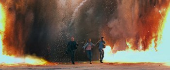 Movie still from “Transformers: Age of Extinction” (2014), directed by Michael Bay – A group of people running in front of a fire; Wide shot, High angle