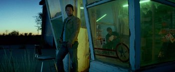 Movie still from “Transformers: Age of Extinction” (2014), directed by Michael Bay – A man standing in front of a store window; Wide shot, Low angle