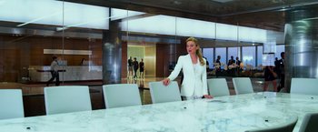 Movie still from “Transformers: Age of Extinction” (2014), directed by Michael Bay – A woman standing in front of a conference room table; Wide shot, Over the shoulder angle