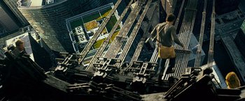 Movie still from “Transformers: Age of Extinction” (2014), directed by Michael Bay – An aerial view of a person walking on a bridge; Wide shot, Overhead angle