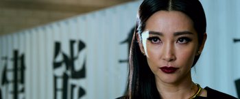 Movie still from “Transformers: Age of Extinction” (2014), directed by Michael Bay – A person with long black hair; Close Up shot, Over the shoulder angle