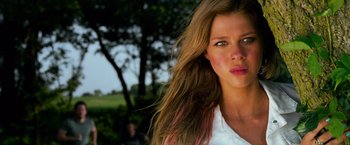 Movie still from “Transformers: Age of Extinction” (2014), directed by Michael Bay – A beautiful young woman with long brown hair and blue eyes; Close Up shot, Low angle