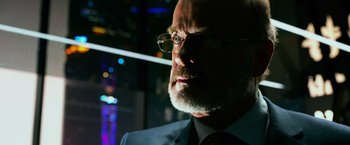 Movie still from “Transformers: Age of Extinction” (2014), directed by Michael Bay – An older man with a beard and glasses looking into the distance; Close Up shot, Low angle