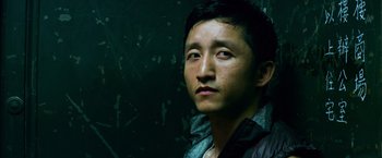 Movie still from “Transformers: Age of Extinction” (2014), directed by Michael Bay – A person wearing a jacket looking up; Close Up shot, Low angle