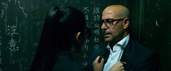 Movie still from “Transformers: Age of Extinction” (2014), directed by Michael Bay – A man and a woman standing in front of a chalkboard; Close Up shot, Over the shoulder angle