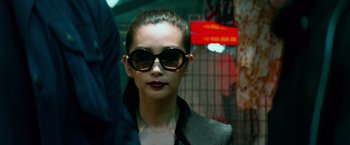 Movie still from “Transformers: Age of Extinction” (2014), directed by Michael Bay – A person wearing sunglasses; Close Up shot, Over the shoulder angle