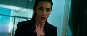 Movie still from “Transformers: Age of Extinction” (2014), directed by Michael Bay – A person wearing a suit; Close Up shot, Over the shoulder angle