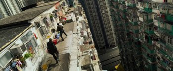Movie still from “Transformers: Age of Extinction” (2014), directed by Michael Bay – A couple of people walking down the side of a building; Extreme Wide shot, High angle