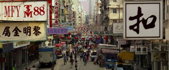 Movie still from “Transformers: Age of Extinction” (2014), directed by Michael Bay – A busy city street filled with people walking on the sidewalk; Extreme Wide shot, High angle