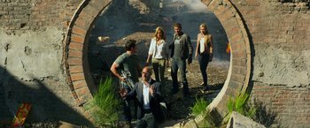 Movie still from “Transformers: Age of Extinction” (2014), directed by Michael Bay – A group of people standing in a field; Wide shot, High angle