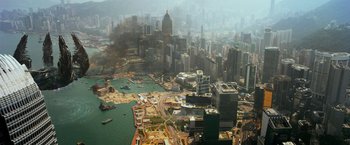 Movie still from “Transformers: Age of Extinction” (2014), directed by Michael Bay – An aerial view of a large city with buildings and water; Extreme Wide shot, High angle
