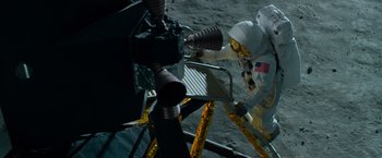 Movie still from “Transformers: Dark of the Moon” (2011), directed by Michael Bay – A person in a spacesuit on the side of the moon; Wide shot, Overhead angle