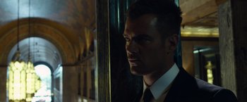 Movie still from “Transformers: Dark of the Moon” (2011), directed by Michael Bay – A person wearing a suit and tie; Close Up shot, Low angle