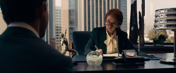 Movie still from “Transformers: Dark of the Moon” (2011), directed by Michael Bay – A woman sitting at a desk writing on a piece of paper; Medium shot, Over the shoulder angle