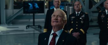 Movie still from “Transformers: Dark of the Moon” (2011), directed by Michael Bay – An older man in a suit and tie looking up; Close Up shot, Low angle