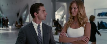 Movie still from “Transformers: Dark of the Moon” (2011), directed by Michael Bay – A man and a woman are standing next to each other; Medium shot, Over the shoulder angle