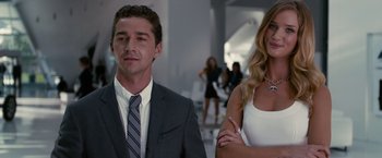 Movie still from “Transformers: Dark of the Moon” (2011), directed by Michael Bay – A man and a woman standing next to each other; Medium shot, Over the shoulder angle