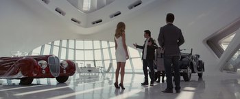 Movie still from “Transformers: Dark of the Moon” (2011), directed by Michael Bay – A group of people standing in a room; Wide shot, Over the shoulder angle