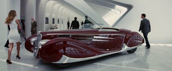 Movie still from “Transformers: Dark of the Moon” (2011), directed by Michael Bay – An antique car is parked in a building; Wide shot, High angle