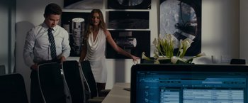 Movie still from “Transformers: Dark of the Moon” (2011), directed by Michael Bay – A woman standing in front of computers in a room; Wide shot, Over the shoulder angle