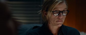 Movie still from “Transformers: Dark of the Moon” (2011), directed by Michael Bay – A person wearing glasses and a black shirt; Close Up shot, Over the shoulder angle