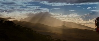Movie still from “Transformers: Dark of the Moon” (2011), directed by Michael Bay – The sun is shining through the clouds on the mountain; Extreme Wide shot, Low angle
