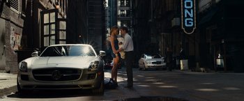 Movie still from “Transformers: Dark of the Moon” (2011), directed by Michael Bay – A man and a woman standing next to each other on the side of the street; Wide shot, High angle