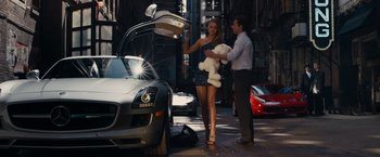 Movie still from “Transformers: Dark of the Moon” (2011), directed by Michael Bay – A man and a woman standing next to a silver car; Wide shot, High angle