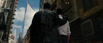 Movie still from “Transformers: Dark of the Moon” (2011), directed by Michael Bay – Two people are hugging in front of a building; Medium shot, Low angle