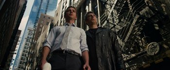 Movie still from “Transformers: Dark of the Moon” (2011), directed by Michael Bay – A couple of men standing next to each other on top of a building; Medium shot, Low angle