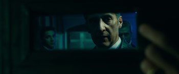 Movie still from “Transformers: Dark of the Moon” (2011), directed by Michael Bay – A person in a suit and tie; Close Up shot, Over the shoulder angle