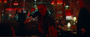 Movie still from “Transformers: Dark of the Moon” (2011), directed by Michael Bay – A man in a leather jacket is in a bar; Medium shot, Low angle