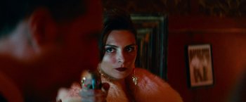 Movie still from “Transformers: Dark of the Moon” (2011), directed by Michael Bay – A woman holding a gun while wearing a pink fur coat; Close Up shot, Over the shoulder angle